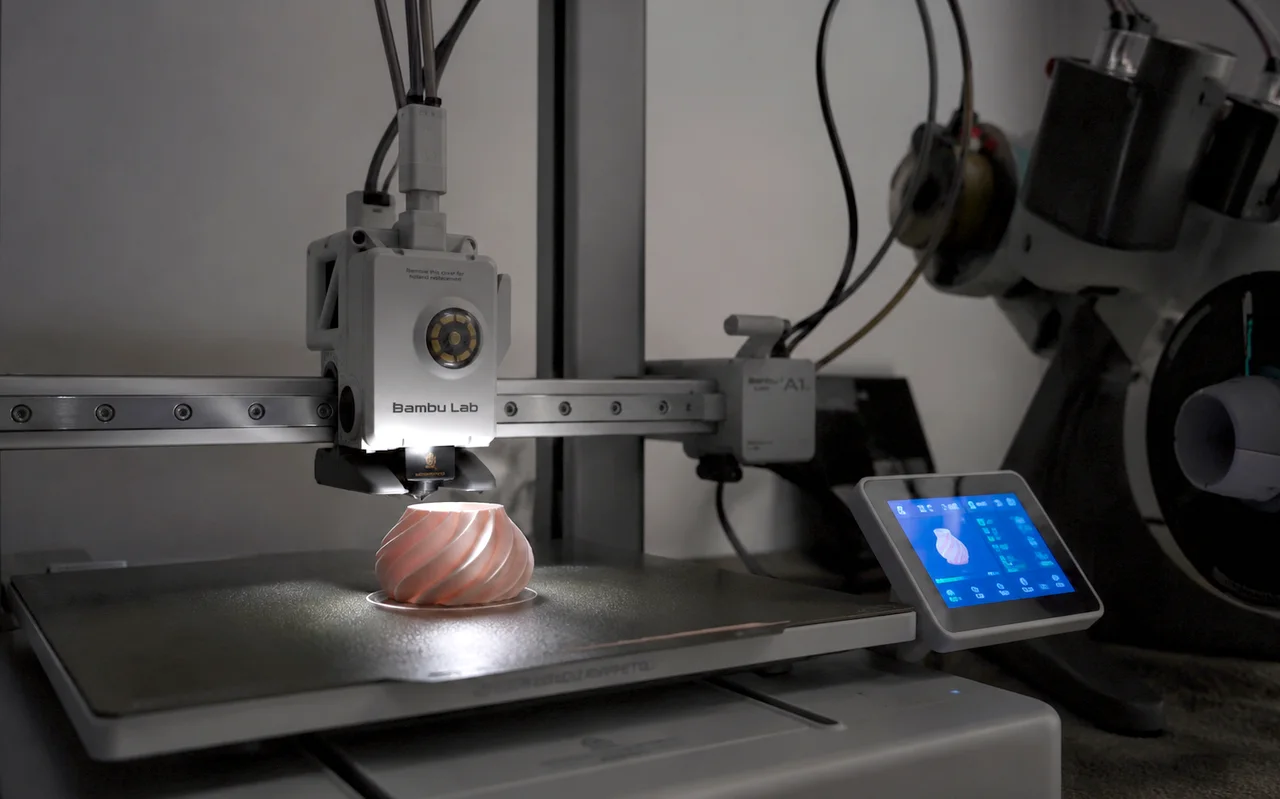 A Bambu Lab A1 mid-print, a spiral vase lit by the toolhead LED